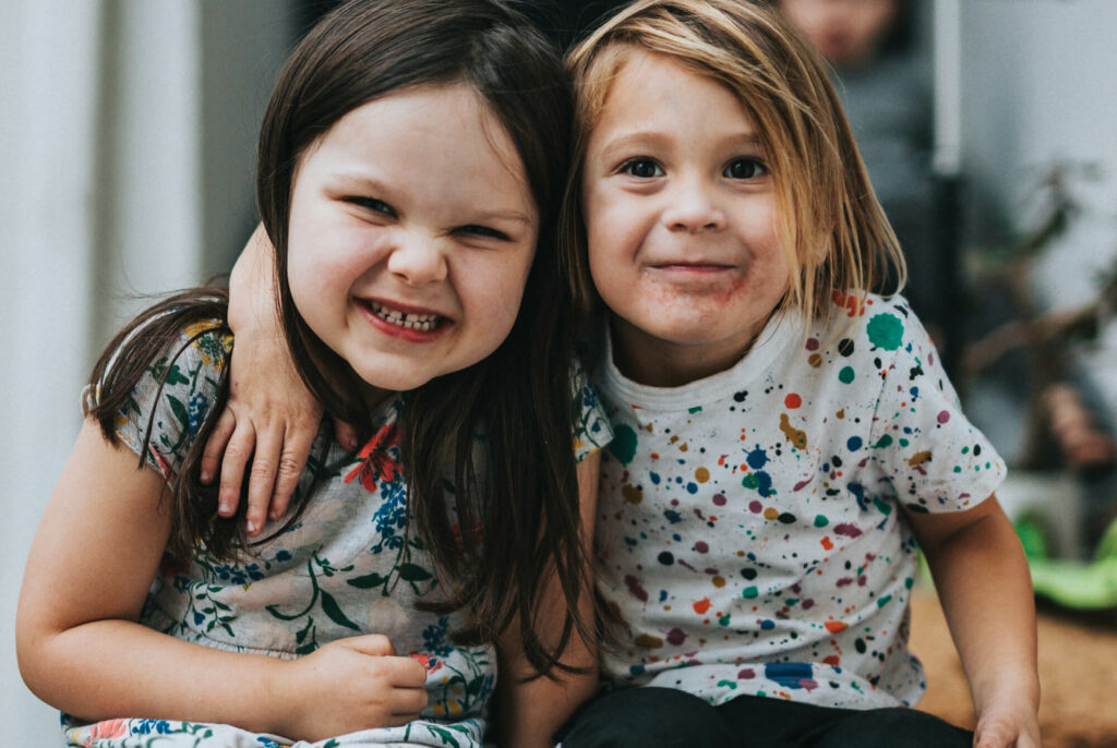 Two smiling and embracing children.